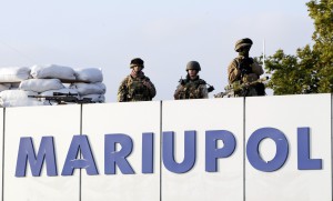 Ukrainian soldiers stand guard at the airport as military personnel and staff meet Ukrainian President Petro Poroshenko in the southern coastal tow