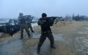 Ukrainian servicemen fire their weapons during fighting with pro-Russian separatists in Pesky village, near Donetsk