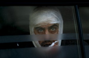 A wounded Ukrainian soldier looks through a windows as he arrives to a hospital in Artemivsk