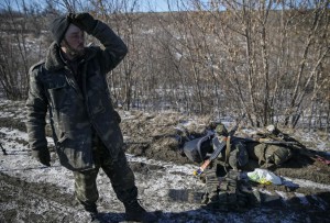 Ukrainian serviceman reacts as he leaves Debaltseve