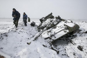 Members of the separatist self-proclaimed Donetsk People's Republic army collect parts of a destroyed Ukrainian army tank in the town of Vuhlehirsk, west of Debaltseve