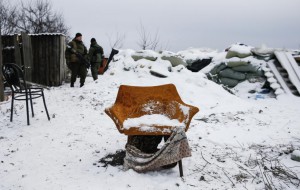 Pro-Russian separatists stand behind an armchair at a checkpoint used by Ukrainian government troops on the outskirts of Vuhlehirsk, eastern Ukraine