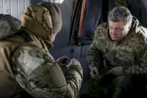 Ukraine's President Poroshenko talks to Chief of Staff of Ukraine's Armed Forces Viktor Muzhenko aboard a helicopter as they travel to Artemivsk to meet servicemen